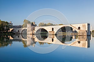 Avignon, famous bridge with Rhone river against blue sky in Provence, France