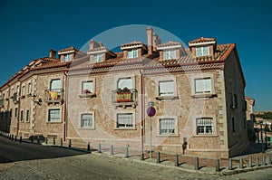 Building on deserted alley with Spanish flag at Avila