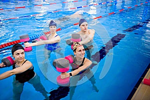 Avka aerobics in the swimming pool. A group of young people in training. photo
