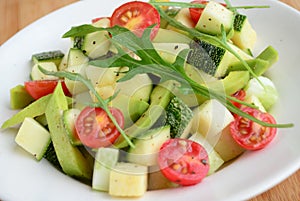 Avocado argula leave salad with cherry tomato vinaigrette dressing