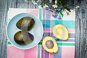 Avocado background with fresh organic avocado on old wooden table, top view