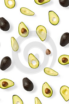 Avocado. Background made from isolated Avocado pieces on white background. Flat lay of fresh ripe avocados and avacado pieces