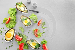 Avocado baked with eggs in foil and fresh vegetables on table