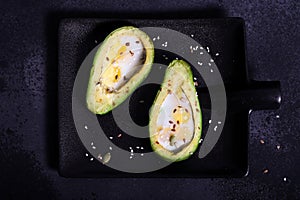 Avocado baked in the oven with quail eggs