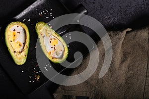 Avocado baked in the oven with quail eggs