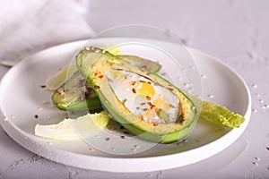 Avocado baked in the oven with quail eggs