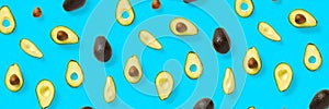 Avocado banner. Background made from isolated Avocado pieces on blue background. Flat lay of fresh ripe avocados and avacado