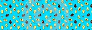 Avocado banner. Background made from isolated Avocado pieces on blue background. Flat lay of fresh ripe avocados and avacado