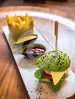 Avocado burger with french fries and sauce