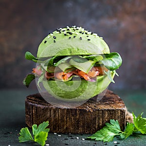 Avocado burger with salted salmon and fresh vegetables