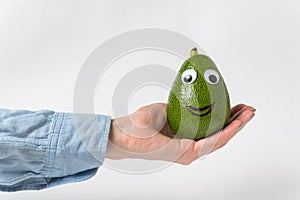 Avocado character on palm on white background. Food with fanny faces. Healthy food concept