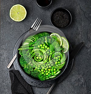 avocado, cucumber, broccoli, asparagus and sweet peas salad, fresh green vegan detox lunch bowl