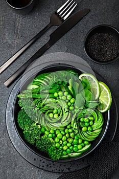 avocado, cucumber, broccoli, asparagus and sweet peas salad, fresh green vegan detox lunch bowl