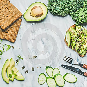 Avocado, cucumber, kale, kress sprouts, pumpkin seeds sandwich, square crop