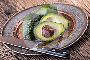 Avocado. Cut avocado on a oak wood background table. Selective focus