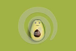 An avocado cut in half with fanny faces in a copy space