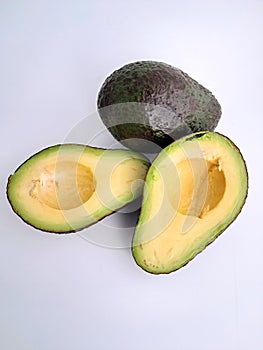 Avocado cut in half on a white background