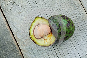 Avocado cut and stacked on wooden.