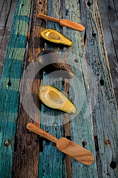 Avocado decorated on wood with wooden shovels