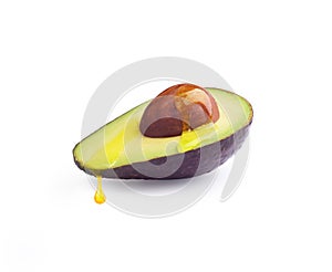 Avocado with a drop of oil on a white background