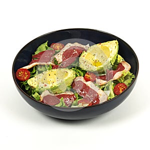 Avocado, duck breast salad in a blue plate