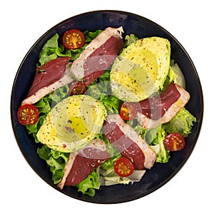 Avocado, duck breast salad in a blue plate
