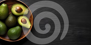 Avocado fruit on bowl copy space dark background