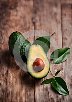 Avocado fruit and leaves on rustic wooden background.