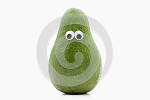 Avocado with googly eyes on white background