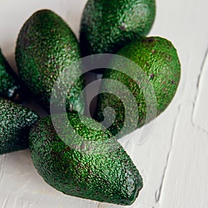 Avocado on the green and white background. Top view