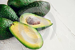 Avocado on the green and white background. Top view