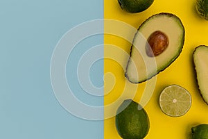 Avocado half on yellow background minimal food