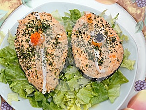 Avocado halves filled with a salmon cream, richly decorated with herbs