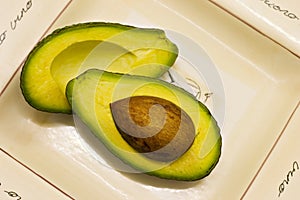 Avocado halves on plate photo