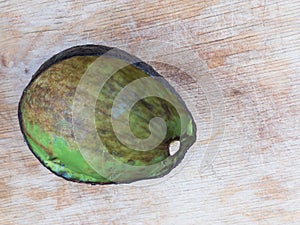 Avocado Hass  rind without pulp lying on a wooden surface