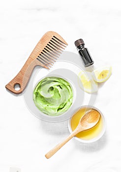 Avocado, honey hair homemade mask on light background, top view. Natural products for hair health