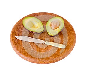 Avocado and knife on breadboard