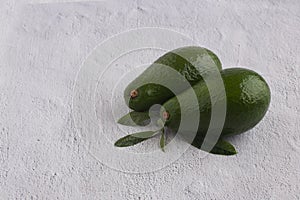 Avocado with leaves on a gray background