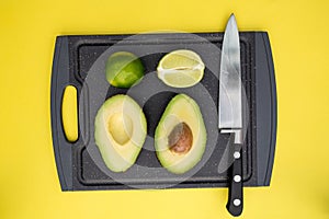 Avocado lime on chopping board with knife