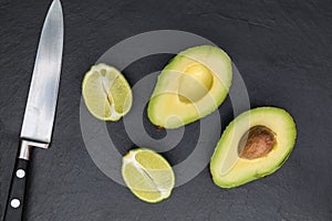 Avocado lime on chopping board with knife