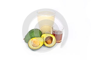 Avocado milk shake with honey ,whole avocado and cut half on white background