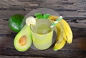 Avocado mix banana smoothies and green juice drink healthy, delicious taste in a glass for weight loss on wooden background.