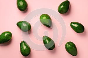 Avocado pattern on pink background. Top view. Banner. Pop art design, creative summer food concept. Green avocadoes, minimal flat