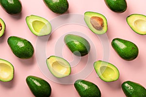 Avocado pattern on pink background. Top view. Banner. Pop art design, creative summer food concept. Green avocadoes, minimal flat