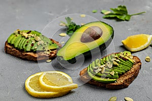 Avocado sandwich on dark rye bread pumpkin seeds, salt and pepper. Vegetarian food. Plant-based diet. Clean eating, Food recipe