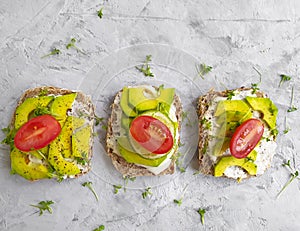 Avocado sandwich nutritious lifestyle on concrete background, recipe tomato