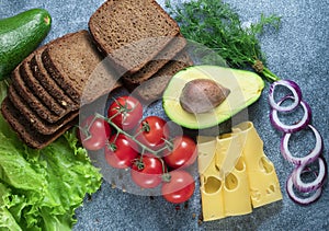 avocado, sandwiches on whole grain bread with tri-colored tomatoes on rustic baking tray