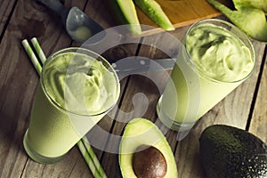 Avocado Shake or Smoothie Being Poured Into Glasses photo