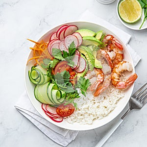Avocado, shrimps, cucumber, tomato, radish, carrot and rice salad bowl. Healthy food