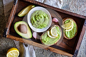 Avocado spread with garlic on wholewheat slice of bread